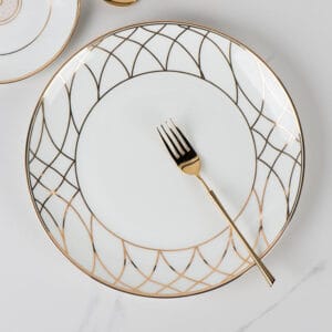 Product Features Light-Luxury Artistic Design: Integrates soft nude pink and exquisite gold elements, with designs ranging from concentric circles with central floral patterns to geometric diamond-grid lines, creating a highly recognizable and elegant visual style. Exquisite Craftsmanship: Features meticulous gilding craftsmanship on the edges, paired with glossy and smooth porcelain, ensuring superior texture and a high-end feel. Versatile Sizing & Scenarios: The multi-size plate set caters to different dining needs and is suitable for both daily meals to add a sense of ritual and high-end banquets to enhance the atmosphere. Aesthetic Hierarchy: The combination of various patterned plates forms a rich visual hierarchy, making it an ideal choice for those who pursue both life quality and artistic aesthetics.