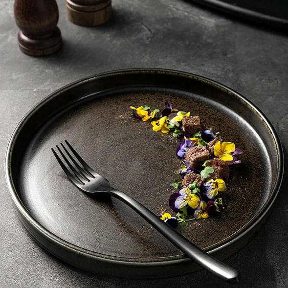 Product Description This tableware set centers on dark brown kiln-change glaze + vintage spiral pattern design, crafted from ceramic. The glaze presents a rich dark brown kiln-change finish paired with understated spiral textures, fitting the dining scenarios of dark-style Western restaurants, Japanese izakayas, and industrial-style home tables, infusing a calm and high-end atmosphere into meals. It blends aesthetics with functionality: The dark brown kiln-change glaze features a vintage matte texture, combining uniqueness and quality; the spiral pattern details enhance visual layers and suit serving diverse dishes like grilled meat, sushi, and thick soups; the multi-vessel combination (plates, bowls, teapots, cups) covers scenarios like formal meals and tea service. Matching with same-color cutlery creates a unified style. Whether for distinctive serving in restaurants or quality family gatherings, this tableware set becomes a textured highlight on the dining table with its calm vintage style.