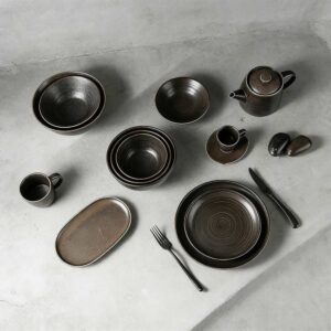 Product Description This tableware set centers on dark brown kiln-change glaze + vintage spiral pattern design, crafted from ceramic. The glaze presents a rich dark brown kiln-change finish paired with understated spiral textures, fitting the dining scenarios of dark-style Western restaurants, Japanese izakayas, and industrial-style home tables, infusing a calm and high-end atmosphere into meals. It blends aesthetics with functionality: The dark brown kiln-change glaze features a vintage matte texture, combining uniqueness and quality; the spiral pattern details enhance visual layers and suit serving diverse dishes like grilled meat, sushi, and thick soups; the multi-vessel combination (plates, bowls, teapots, cups) covers scenarios like formal meals and tea service. Matching with same-color cutlery creates a unified style. Whether for distinctive serving in restaurants or quality family gatherings, this tableware set becomes a textured highlight on the dining table with its calm vintage style.